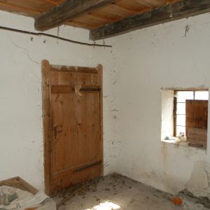 Interiér chyžky, vstupné dvere a okno